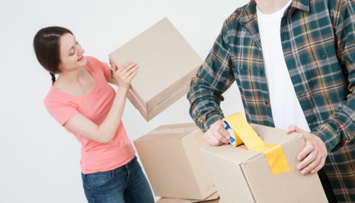 Removal team carrying furniture from a Croydon property