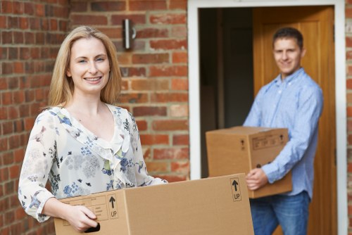 Local movers handling furniture in a Croydon street