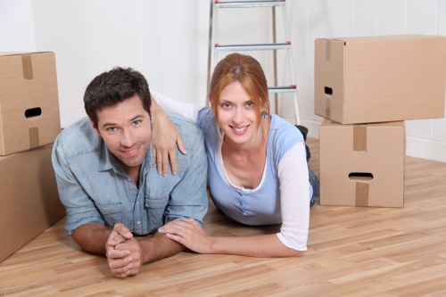 Moving team carrying boxes in a Croydon residential area