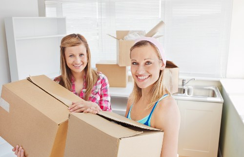 Delivery van unloading items at a property with careful handling