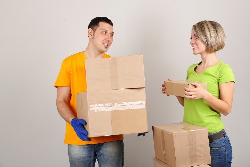 Staff assessing lifting safety before handling heavy furniture